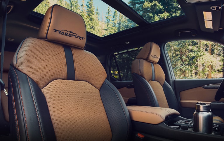 2026 Honda Passport TrailSport Elite front seats with TrailSport stitching and panoramic sunroof (Mid-Size SUV).